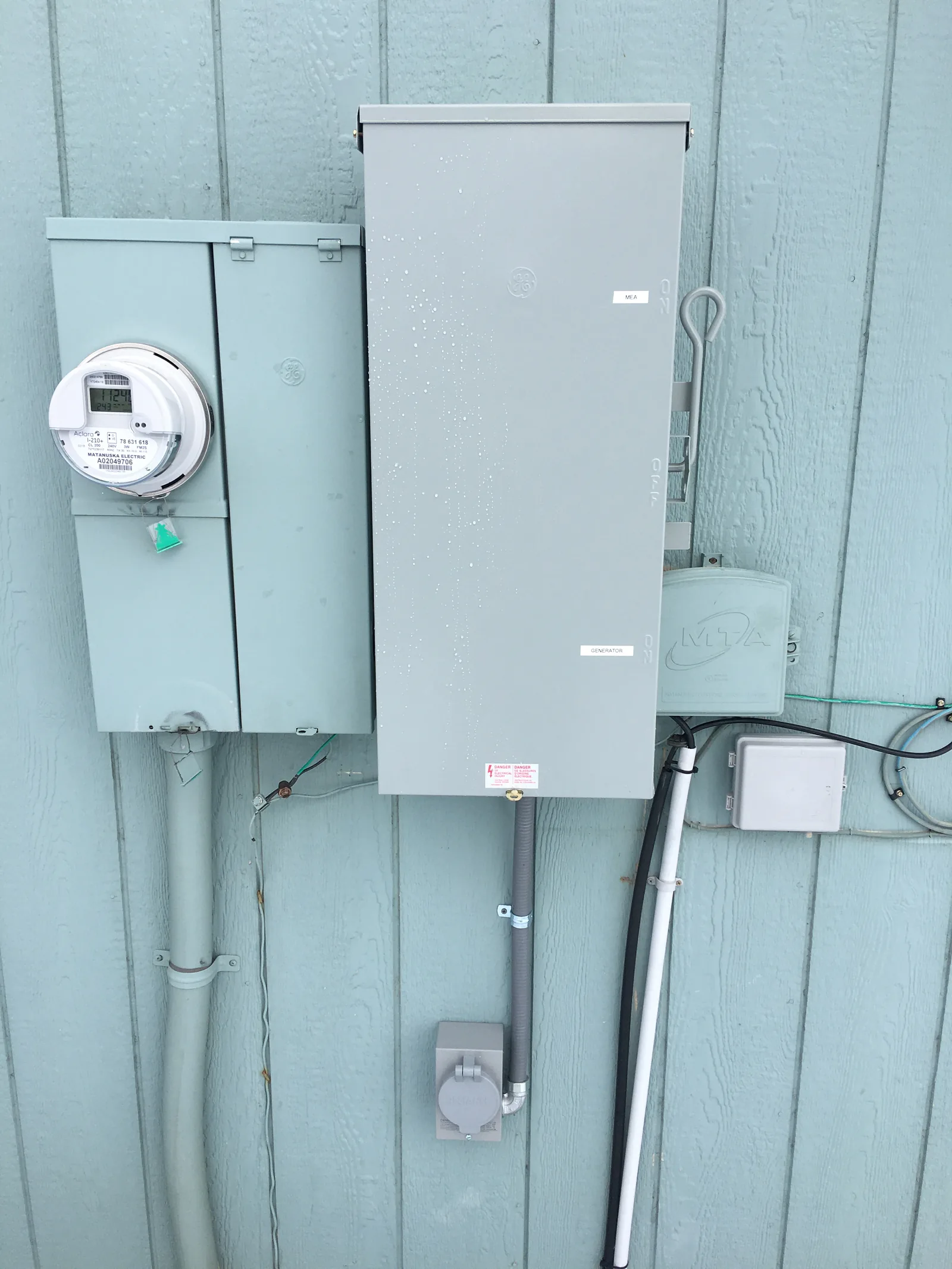 Generator transfer switch and meter installed on the exterior of a Mat-Su Valley home